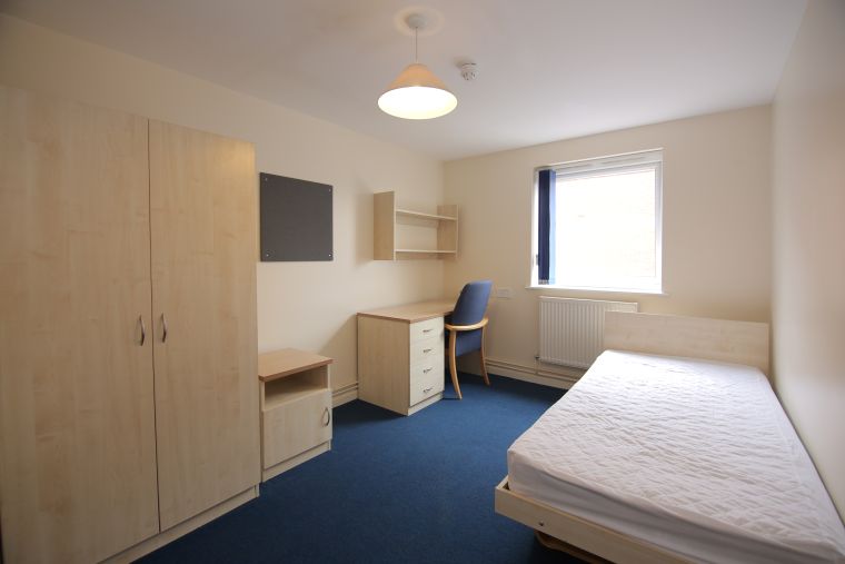 Bedroom with a desk and wardrobe